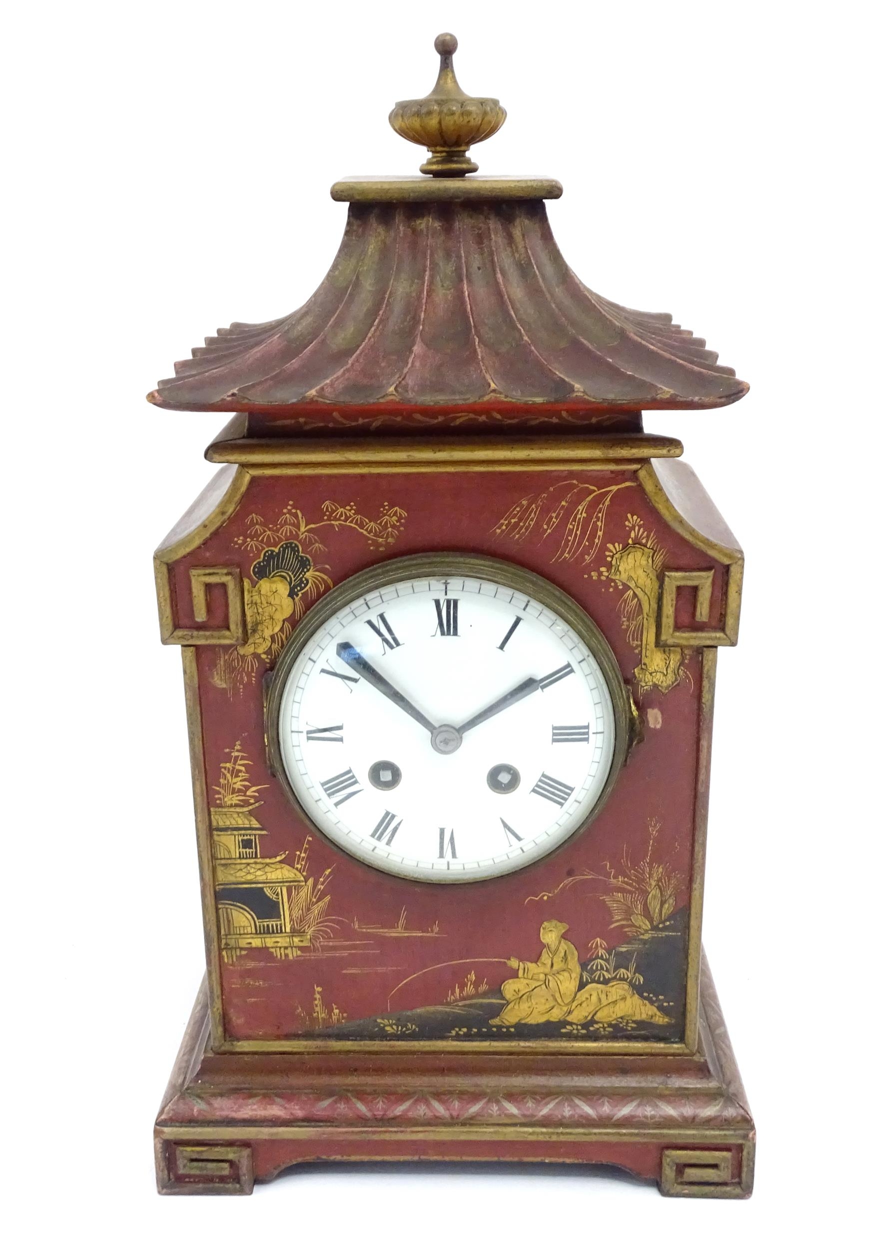 A French Chinoiserie mantle clock the white enamel dial with 8-day movement striking on a gong.