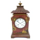 A French Chinoiserie mantle clock the white enamel dial with 8-day movement striking on a gong.