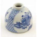 A Chinese blue and white ink pot of dome form decorated with scholars with scrolls in a landscape.