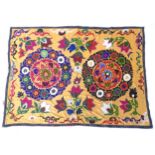 Carpet / rug : An Uzbek Suzanie embroidered textile, the yellow ground embroidered with floral and