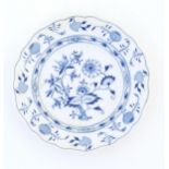 A Meissen style blue and white plate decorated in the Onion pattern. Crossed sword mark under.