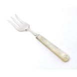 A silver three tine bread fork with a mother of pearl handle, hallmarked Sheffield 1923, maker