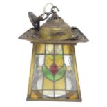 An Arts and Crfts pendant light of lantern form with leaded stained glass panels. Approx 9" wide x