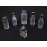 Assorted silver mounted bottles to include cut glass cruet bottles together with two toilet jars,