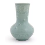 An Oriental celadon glazed vase decorated with crane birds and flowers. Character marks under.