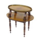 A mid / late 19thC rosewood two tier table with a brass galleried top above four incised, concave