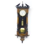 A Victorian walnut cased Vienna regulator style wall clock with enamel dial. Approx 35" high overall
