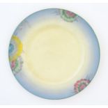 A Clarice Cliff plate decorated with a floral border. Marked under. Approx. 10" diameter Please Note