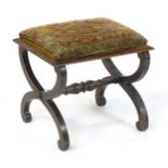 A 19thC X- frame stool with an upholstered top and moulded rim, the base having applied roundels and