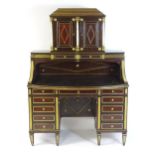 An early 19thC Russian mahogany, brass and giltwood desk, The upmost section having a stepped top