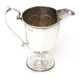 A silver cream jug hallmarked Birmingham 1928, maker Mappin & Webb. Approx. 4" high Please Note - we