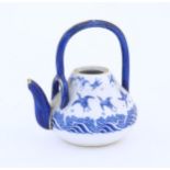 A Minton teapot decorated in the pattern Japanese Crane, designed by Christopher Dresser, with