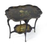 A 19thC ebonised table with two papier machete tiers. both tiers formed from tray tops and having
