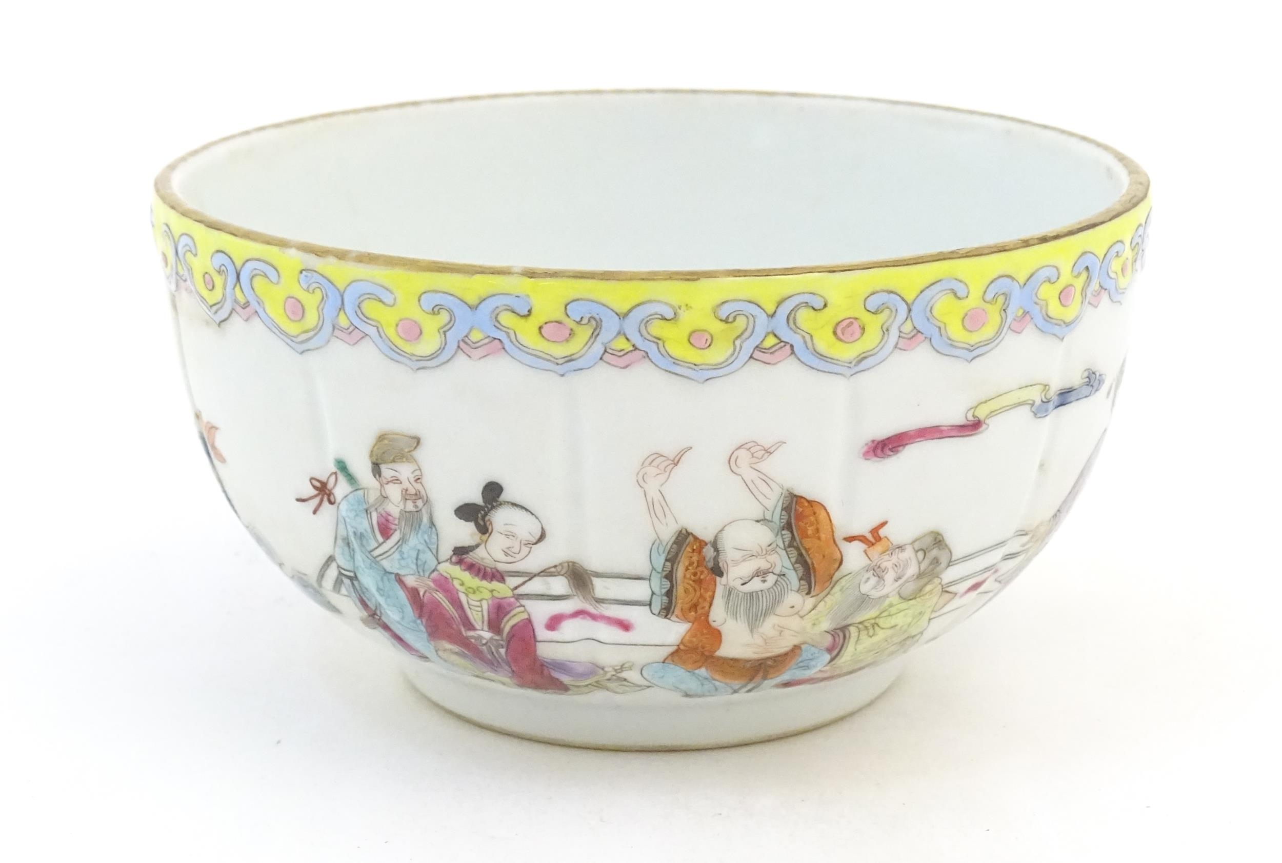 A Chinese famille rose bowl decorated with figures in a stylised landscape. Approx. 3" high x 5"