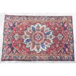 Carpet / rug : A Bakhtiar rug with central stylised floral medallion surrounded by a red ground with