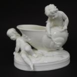 A Victorian Mintons blanc de chine shell formed spoon warmer with putti / cherub decoration.