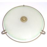 A retro ceiling light, the brass frame with circular glass shade. Approx 23" wide Please Note - we