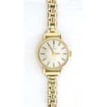 A 9ct gold ladies Tissot wrist watch. Approx 3/4" wide Please Note - we do not make reference to the