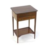 An early 19thC mahogany side table with a hinged lid above a small drawer and raised on four