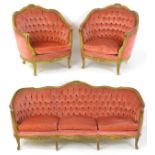 A mid 20thC salon suite comprising two armchairs and a settee. All three pics having carved show
