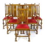 A set of six early 20thC oak dining chairs surmounted by turned finials above a marquetry inlaid