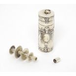 A silver sewing thread spool / needle case with embossed decoration. Marked sterling under.