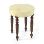 A 19thC oversized mahogany stool, having a circular top above four turned and canted legs
