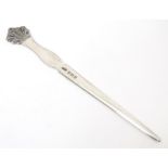 A silver letter opener the handle surmounted by foliate decoration, hallmarked Birmingham 1971,