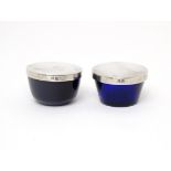 Two blue glass liners with silver tops, hallmarked Birmingham 1926. Approx. 1" high (2) Please