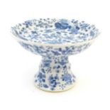 A Chinese blue and white tazza with floral, foliate, butterfly and insect decoration. Approx. 5 1/2"