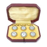A cased set of 6 buttons/studs with mother of pearl and turquoise enamel detail. Approx 5/8"