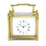 A French brass cased carriage clock with white enamel dial signed ' S Barnett Peterborough ' the