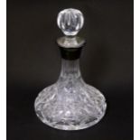 A small cut glass ships decanter with silver collar hallmarked Birmingham 1989 maker P H Vogel & Co.