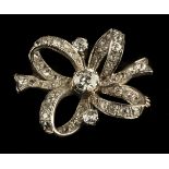 * Diamond Brooch. A white metal diamond ribbon brooch