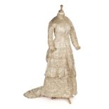 * Dress. A cream satin wedding gown with bustled trained skirt, circa 1880s