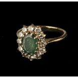 * Emerald Ring. An 18ct gold emerald and diamond cluster ring
