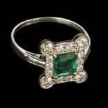 * Emerald and Diamond Ring. An art deco emerald and diamond cluster ring