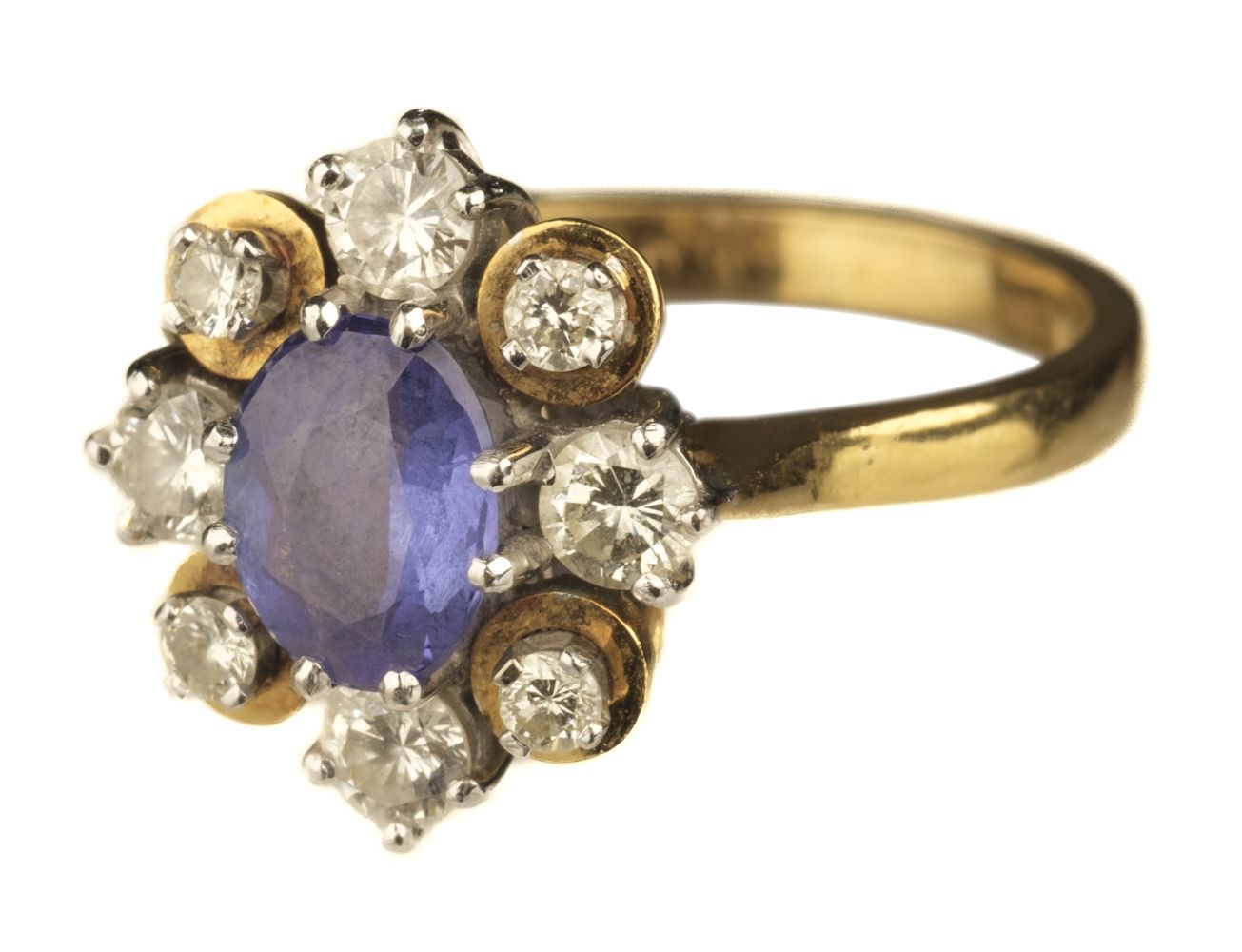 Ring. An 18ct gold sapphire and diamond cluster ring