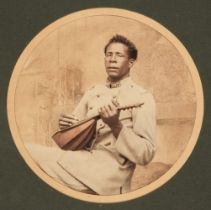 Africa. Portrait of an African man in French army uniform playing a lute, c. 1890