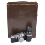 Leica IIIf film camera with several lenses and accessories