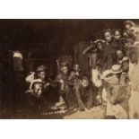 Indochina. A group of Chinese men and children in a huddled group, c. 1890, albumen print on card
