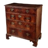 AN EARLY GEORGE II WALNUT CHEST OF DRAWERS