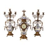 A 20TH CENTURY FRENCH PORCELAINE AND GILT METAL CLOCK GARNITURE