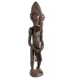 AN OCEANIC CARVED WOOD FIGURE
