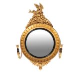 A REGENCY STYLE CARVED GILTWOOD CONVEX MIRROR