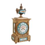 A FRENCH BRASS CASED MANTLE CLOCK WITH SEVRES STYLE PORCELAIN PANELS