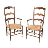 A PAIR OF FRENCH PROVINCIAL OAK RUSH SEAT ARMCHAIRS