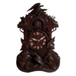 AN EDWARDIAN BLACK FOREST MANTEL CLOCK