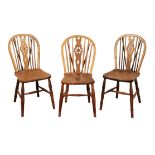 A HARLEQUIN SET OF EIGHT WHEEL-BACK DINING CHAIRS