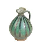 A PERSIAN GREEN-GLAZED POTTERY EWER, possibly 12th Century